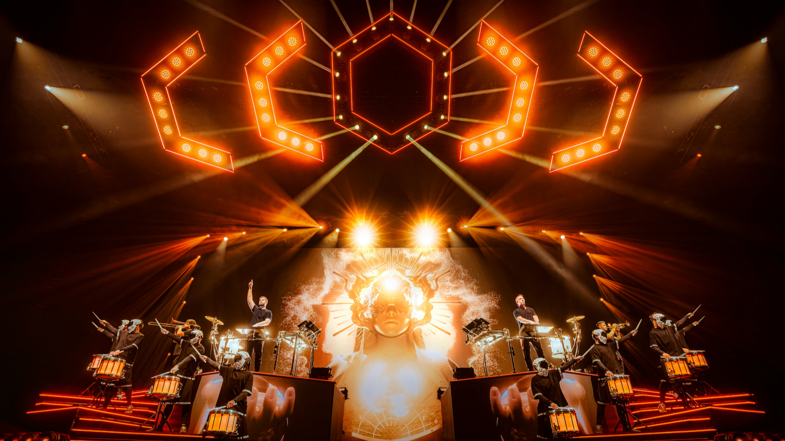 ODESZA performing beneath a vast rig of amber lights